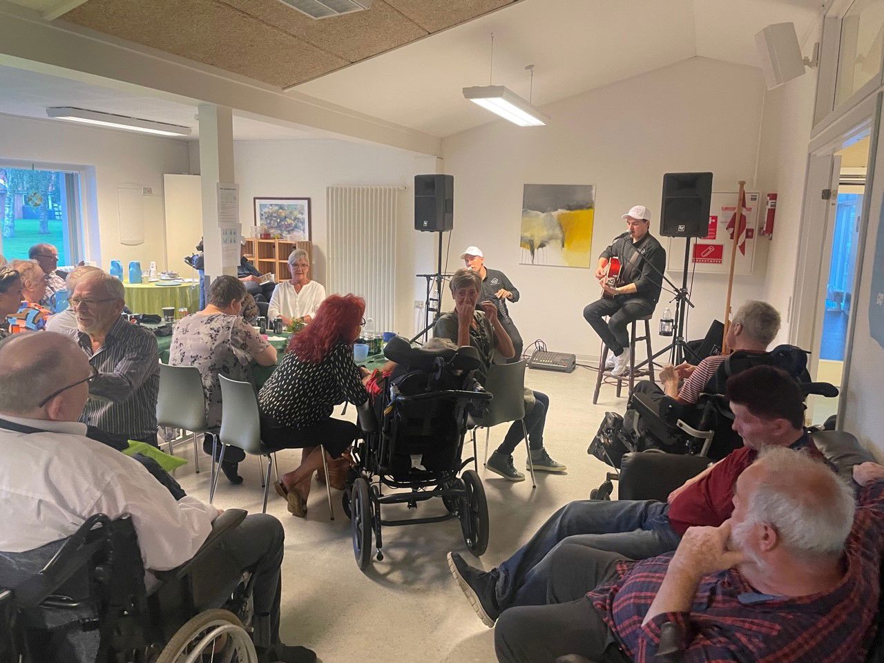 Gruppen MD Duo fra Thy spiller op til dans, både borgere og medarbejdere sidder og nyder musikken. Der bliver snakket og hygget.